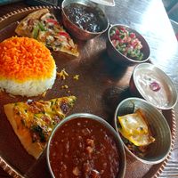 Mixed traditionell iranien food plate with beans, salad, soyjoghurt, rice, salad, Fesendjan, lasagna, pizaa at Iranian Artist's Forum - Khaneh Honarmandan Iran in Tehran
