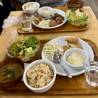Set meal including miso soup, salad, rice, coleslaw, creamy potatoes, and kuruma fu (Japanese wheat gluten disk) with onions. at Crayon House in Tokyo