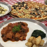 Delicious vegan pizza and vegan meat in tomato sauce at Govinda Italian Restaurant & Pizzeria in Bangkok