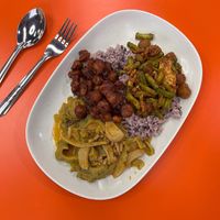 Spicy red curry with bitter gourd and oyster mushrooms, crispy sweet glazed soybeans, and green beans with tofu and fake meat.  at Rabiengboon - MBK in Bangkok