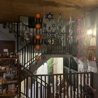 The staircase area is besutifully decorated with a mural of a waterfall and birds (which seem to be flying in the air in front of it!)  at Aum in Chiang Mai