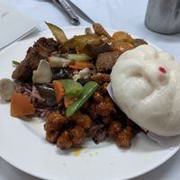 Steamed bun and assortment of entrees at Hesan Vegetarian in Phuket