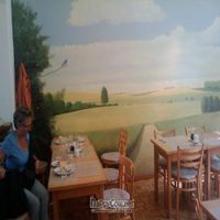 The cafe is decorated very simply with peaceful wall murals at Den Teepot in Brussels