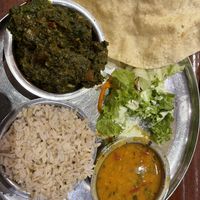 Menu with three dishes. Rice, lentils and potatoes with spinach    at Govinda's in London