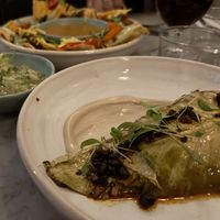 Chorizo Nachos plus Tomatillo Guacamole alongside Hot and Sour Cabbage  at Mildreds - Soho in London
