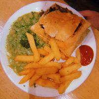 Wood roasted mushrooms and ale pie with minted mushy peas and fries  at Mildreds - Soho in London