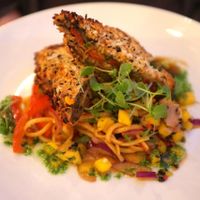 Teriyaki aubergine V
Char grilled aubergine layered with coriander pesto, roasted red peppers, shitake mushrooms and fresh horseradish, coated with crispy breadcrumbs and served on stir fried noodles with a pickled ginger and mango salad. at The Gate - Hammersmith in West London