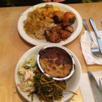 A bit of everything on offer! All Vegan.

Top Dish - Caribbean curry, kofta, quinoa and roasties.
Bottom Dish - potato lasagna, coleslaw and carrot, coriander and almond salad. at Earth Cafe in Manchester
