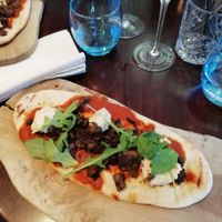 Flatbread with tomato sauce, hummus, paprika mushrooms and crispy capers at Greens in Manchester