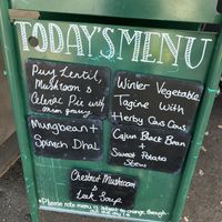 Board outside   at The 8th Day in Manchester