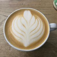 Oat milk latte at The 8th Day in Manchester