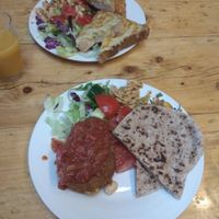 Vegan bean burger with a tomato sauce, pitas and salads at The Egg Cafe in Liverpool
