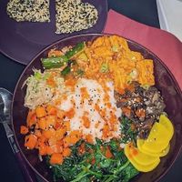 Home delivery of Korean Bibimbap: spicy tofu, pepper spice, kimchi, wilted sesame spinach, carrots & nori, marinated beansprouts, mixed mushrooms in soy & sesame crunch biscuits at Blue Moon Cafe in Sheffield
