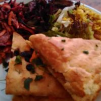 Marinated tofu sandwich on olive bread with rice and salad. at Herbies in Exeter