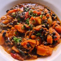 Black bean casserole, I had this with vegan cheesy garlic bread, so good! at Herbies in Exeter