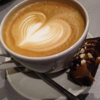 Caffe latte and raw vegan dessert about 8 euro. at Silvoplee in Helsinki