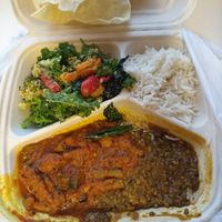 Take-away-box with curries, rice, some salad, and poppadums. at Gopal in Tampere