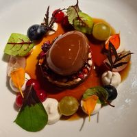 Uovo di gianduja, biscotto di miglio, semi e cioccolato, spuma di cocco e frutti di bosco, salsa di caffè at Joia Alta Cucina Naturale in Milan