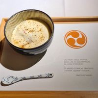 Golosa variazione di ciliegie, pesca e sambuco, crumble di saraceno, gratinati con crema chantilly profumata alla vaniglia at Joia Alta Cucina Naturale in Milan