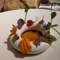 Course 8: Coconut cream ring topped with a variety of fruit drops and herbs at Joia Alta Cucina Naturale in Milan