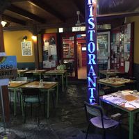 This is the restaurant from inside the court, showing outdoor dining. at Amico Bio - Un Sorriso Integrale in Naples