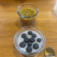 Blueberry chia pudding in the foreground and a tropical pudding in the background. at Harmonie Bowl & Juice in Strasbourg