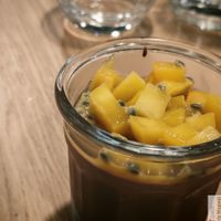 A creamy, sugar-free plant-based cream with a guaranteed cocoa content of over 70%, mango coulis, and passion fruit. at Harmonie Bowl & Juice in Strasbourg
