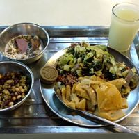 Rice, vegetables, green bean cake, mixed beans, yam (or similar) in coconut milk with other stuff, unsweetened indian gooseberry drink. at Chiang Mai Vegetarian Society in Chiang Mai