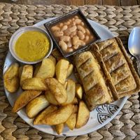 Vegan sausage roll with chips, beans and curry sauce, $5.75  at New Leaf Eatery in Siem Reap