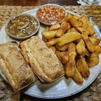 Vegan sausage rolls served with delicious potatoes, baked beans, and mushroom gravy at New Leaf Eatery in Siem Reap
