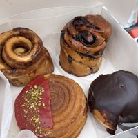 Rollito de canela, babka de chocolate, croissant con pistachio y cereza, Boston crema  at Delish Vegan Doughnuts in Madrid