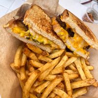 Melty patty melt oozing with pickle chips,  cheese, and sautéed onions! at Seed Ranger in Ventura