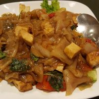 Pad Kee Mow - aka Drunken Noodle, made with thick rice noodle pan fried with tofu, tomato, Thai basil, spicy chopped fresh chilies, and soy sauce. at Thai Basil in Cameron Park
