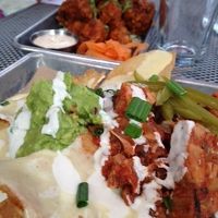 Nachos with added jackfruit and cauliflower wings in the background. at BoltCutter in Salt Lake City