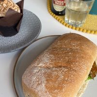 Sausage sarne and biscotti and chocolate muffin yum 🤤   at Square Roots in Whitley Bay