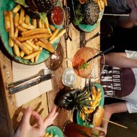 Burger with fries, wildberry lillet and homemade lemonade at Bidges & Sons Reeperbahn in Hamburg