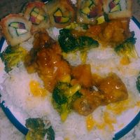 Spicy tuna roll and orange "chicken" on a plate at my house at Veggie House in Salt Lake City