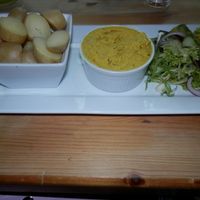 Boiled potatoes, hummus and salad. at Marriott's Warehouse in Kings Lynn