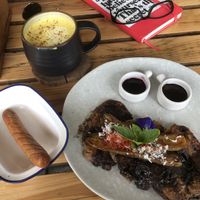 Vegan pancakes, sausage and turmeric latte with coconut milk  at The Factory Cafe in Koh Tao