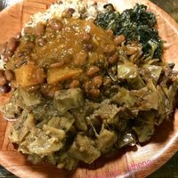 Jamaican Rice, coconut creamed spinach, steamed cabbage, jerk eggplant, and red beans. at Caribbean Connection in Lewisburg