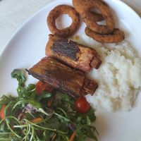 "Ribs" with polenta and onion rings at Ecosteria Parco Santi Angeli in Santi Angeli