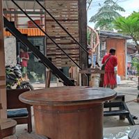 Owner administering medicine to dogs at Bom Bowls in Pai