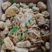 Kanpai Japanese Noodle dish with added popcorn chicken. Popcorn chicken is good. The dish itself is good but could use more flavoring/ sauce at Foo Dog Curry Traders in Jacksonville