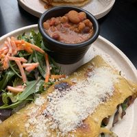 vegan omelette with a side of beans, pancakes in the background at Shift Eatery in Surry Hills