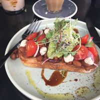 Smoky baked beans with a avocado smash, tomatoes and cashew cheese at Shift Eatery in Surry Hills