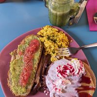 Combo platter with pancakes, tofu scramble, "bacon", and toast with avocado and tomato at Freedom Cakes Bakery in Madrid