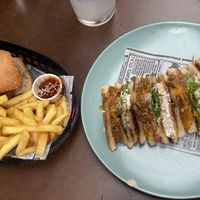 Calamari sandwich and fries on the left, Club sandwich on the right   at Freedom Cakes Bakery in Madrid