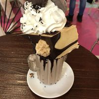 Chocolate freak shake with a slice of peanut cake, chocolate palmeritas and whipped cream at Freedom Cakes Bakery in Madrid