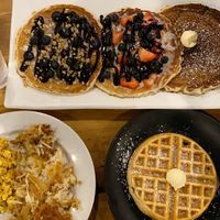 The Usual with tofu scramble, vegan sausage and hashbrowns, trilogy pancakes, and belgian waffle at Seven Mile Cafe in Keller