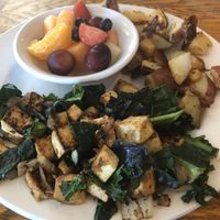 Tofu scramble with Kale and onions, and a side of potatoes and fruit  at Bentley's House of Coffee & Tea in Tucson